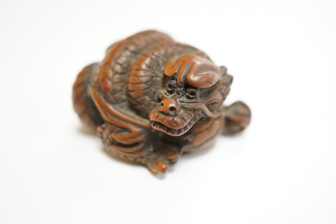 A 19th century Japanese carved wood ‘dragon’ netsuke, 4cm wide
